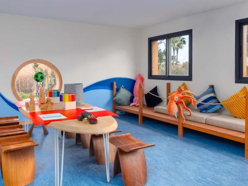 a living room with a couch and a table at Sofitel Agadir Thalassa Sea & Spa in Agadir