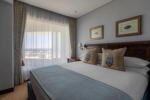 Postel nebo postele na pokoji v ubytování Hotel Cardoso