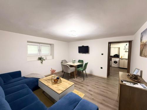 a living room with a blue couch and a table at ToP center of Varna in Varna City