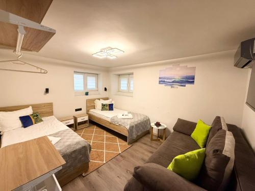 a living room with a couch and a bed at ToP center of Varna in Varna City