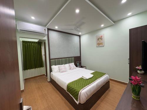 a bedroom with a bed and a projection screen at Vijay residency in Tiruchirappalli