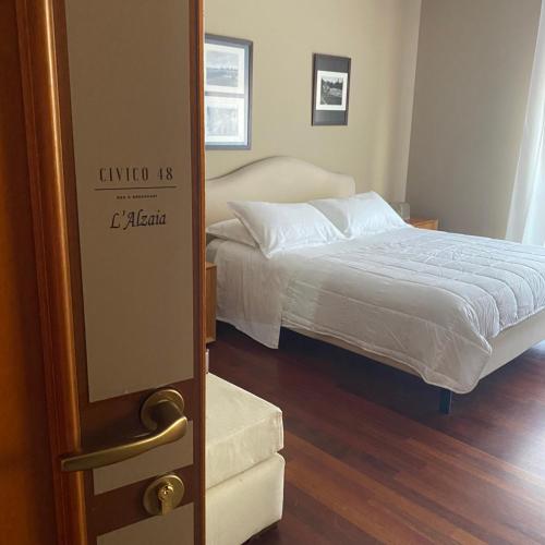 a bedroom with a bed and a door to a room at Civico 48 in Vizzola Ticino
