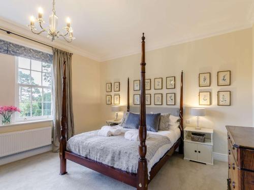 a bedroom with a canopy bed and a chandelier at 5 bed in Markington 83892 in Bishop Thornton
