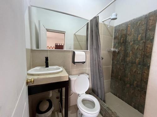 a bathroom with a toilet and a sink and a shower at Bahia B&B in Bahía de Caráquez