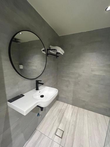 a bathroom with a white sink and a mirror at ovation Studio in Riyadh