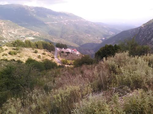 a house on top of a hill with mountains at Elova in Zátouna