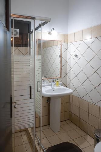 a bathroom with a sink and a shower at Semeli Guesthouse in Karpenisi