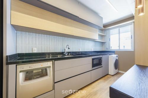 a kitchen with a sink and a dishwasher at House with Jacuzzi, just 10min from the sea OSH in Florianópolis