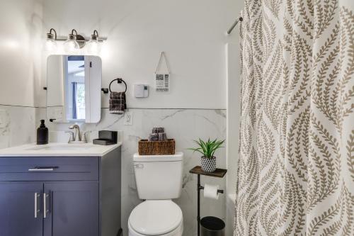 a bathroom with a toilet and a sink and a shower at Hot Tub and Game Room Wooded Poconos Retreat in Pocono Country Place