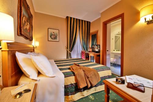 מיטה או מיטות בחדר ב-Colonna Hotel