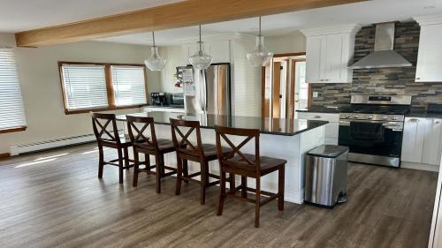a kitchen with a table with chairs and a stove at Charming, Recently Renovated 3 Bedroom Beach Block In Ship Bottom in Ship Bottom