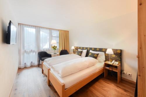 Ein Bett oder Betten in einem Zimmer der Unterkunft Hotel Krone Lenk