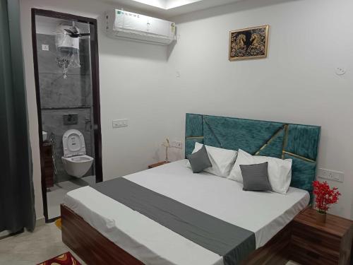 a bedroom with a bed and a bathroom with a toilet at Collection O South City 1 Arcadia in Gurgaon