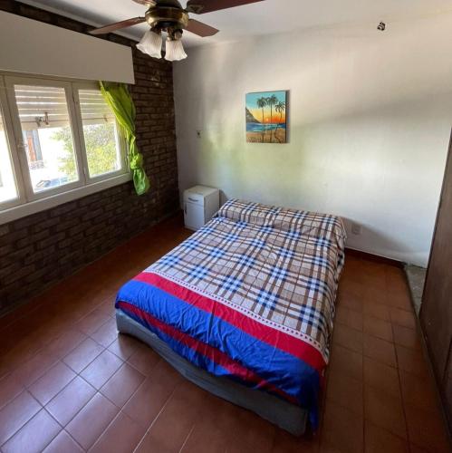 a bedroom with a bed and a ceiling fan at Centro de Rafaela Para 2 Personas in Rafaela