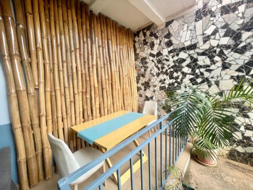 a room with a table and a bamboo wall at Maison Meublé de 3 CH Essos in Yaoundé