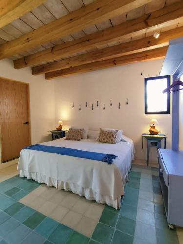 a bedroom with a bed in a room with wooden ceilings at El Diablo y La Luna B&B by El Diablo y La Sandia in Oaxaca City
