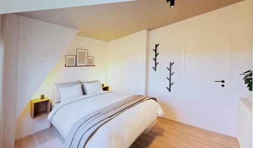 1 dormitorio con 1 cama grande y paredes blancas en Casa Blanc - Coastal Triplex, en Blankenberge