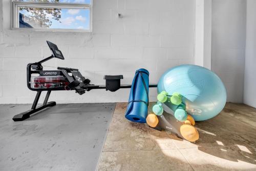a gym with an exercise ball and a machine at Close to beaches BBQ workout gear private yard in Largo