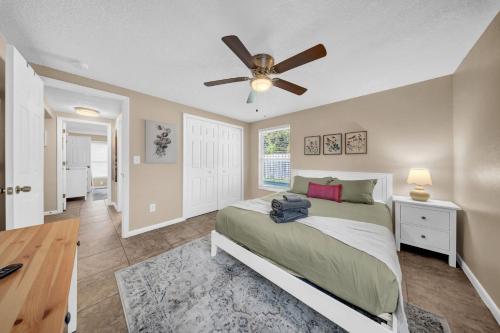 a bedroom with a bed and a ceiling fan at Close to beaches BBQ workout gear private yard in Largo