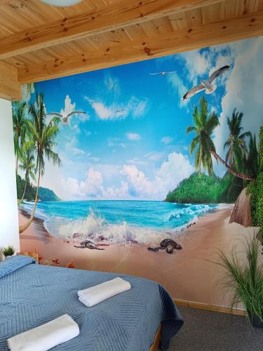 a mural of a beach with palm trees and the ocean at Apartamenty Liberta in Stare Jabłonki