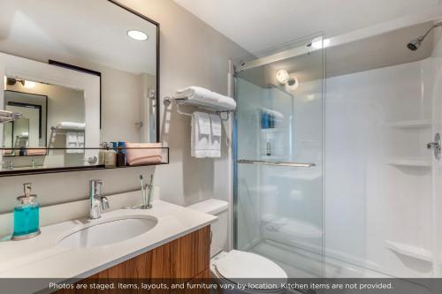 a bathroom with a shower and a sink and a toilet at Uptown Suites Extended Stay Tampa FL - Riverview in Riverview