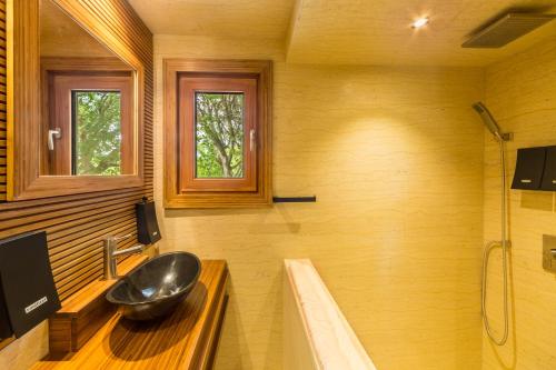 a bathroom with a sink and a bath tub at Kokomo Ultra-lux King - King Cottage in Turtle Cove