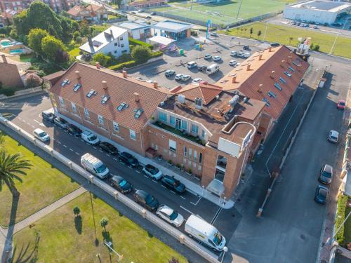 an overhead view of a building with a parking lot at Chateau La Roca in Sancibrián