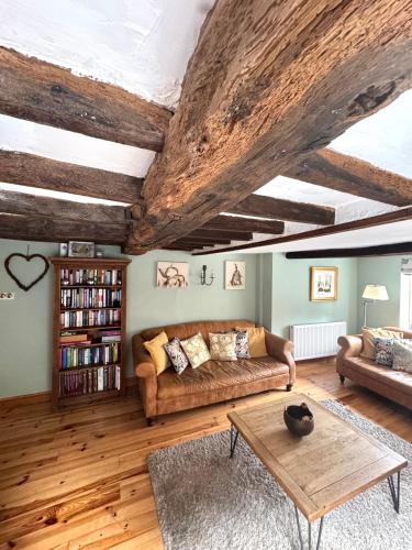 a living room with a couch and a coffee table at The Old Ropery at Mill Cottage - Sherwood Forest in Ollerton