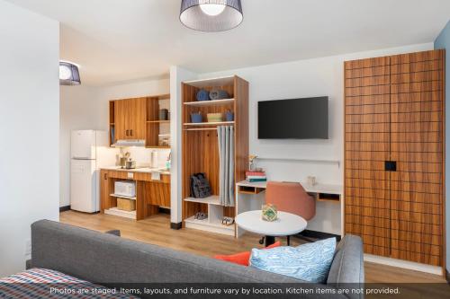 a living room with a couch and a desk at Uptown Suites Extended Stay Charlotte NC - Concord in Concord