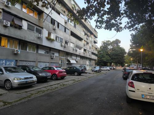 a group of cars parked next to a building at Nina Urban Apartment-Novi Beograd in Belgrade