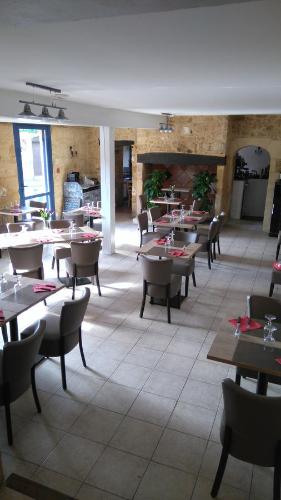 une salle à manger avec des tables et des chaises dans un restaurant dans l'établissement Hotel Restaurant La Traverse, à Cénac-et-Saint-Julien