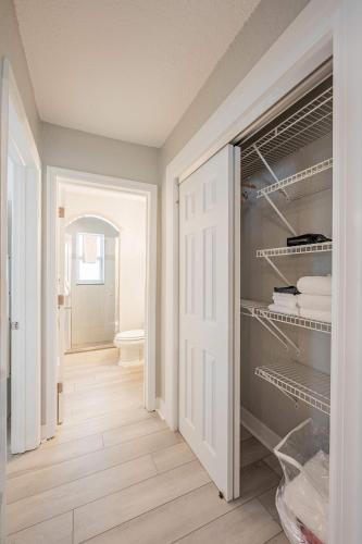 a room with a closet with a door open at Blue Wave Suites in Clearwater Beach
