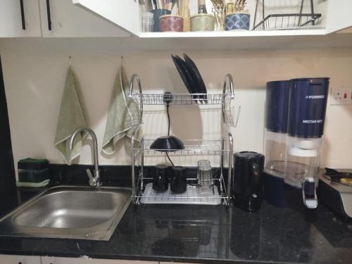 a kitchen counter with a sink and utensils at Lakeview Apartments - The Nest in Mbita
