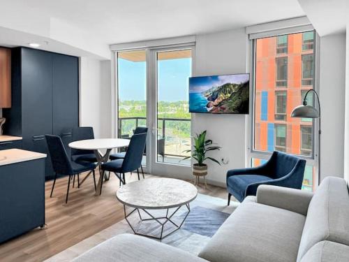 a living room with a couch and chairs and a table at The Stay 1 - Navy Yard Washington DC in Washington, D.C.