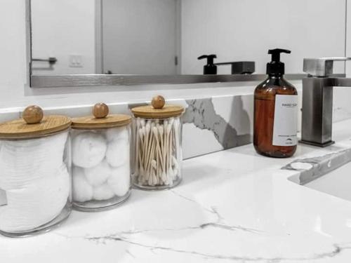 a kitchen counter with three jars and a bottle of wine at The Stay 1 - Navy Yard Washington DC in Washington