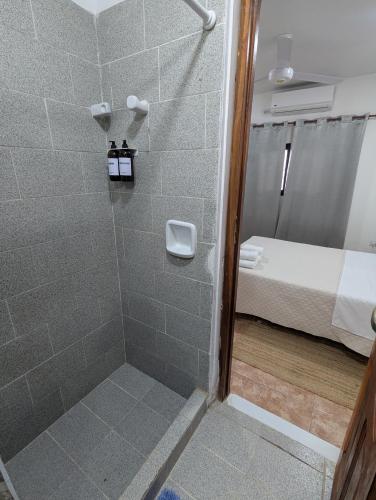 a bathroom with a shower and a bed in a room at Di Arte 1 - A 200 metros de la Terminal - con Cochera in Formosa
