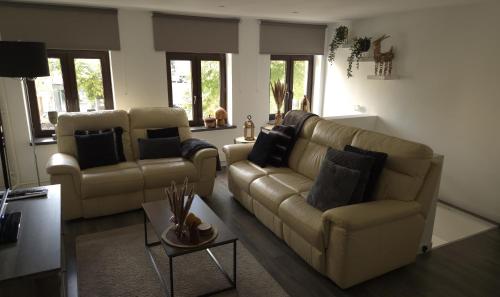a living room with two couches and a table at Appartement Falchenberch in Valkenburg