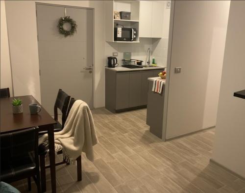 a small kitchen with a table and a table and chairs at Centro I Costanera I Con Estacionamiento I 2Habs in Puerto Montt