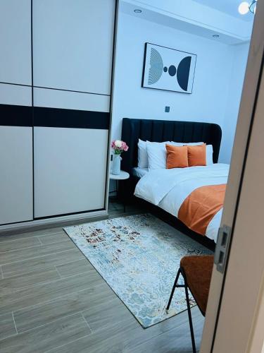 a bedroom with a bed and a mirror at Raydil Homes in Nairobi