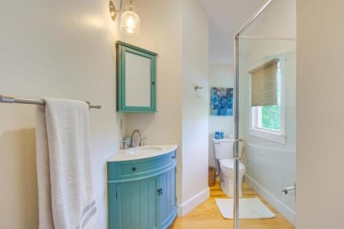 a bathroom with a blue sink and a toilet at Romantic, Secluded Vermont Getaway with Hot Tub in Hancock
