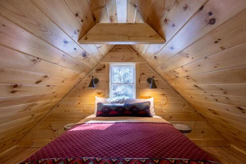 a bedroom in a tree house with a bed at Retreat at Riverbend in West Jefferson