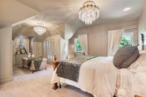 a bedroom with a large bed and a chandelier at DavidFisher House historic lux Sleeps 12 4br3ba in Heber City