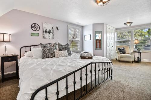 a bedroom with a large bed and a chair at 2 Heber homes lg groups 7br 5ba hot tub decks in Heber City