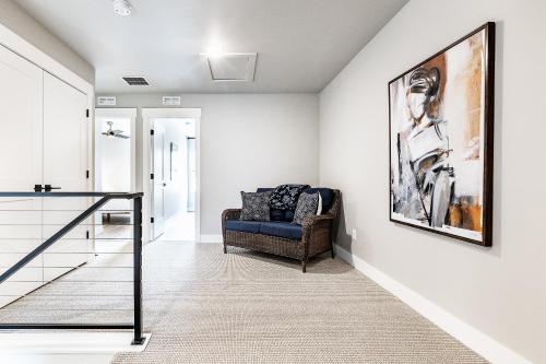 a living room with a couch and a painting on the wall at Great views luxe gym fireplace deck sleeps 8 in Cranmer