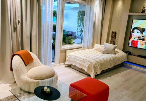 a bedroom with a bed and a chair and a window at Apartment, everything close in Hamar