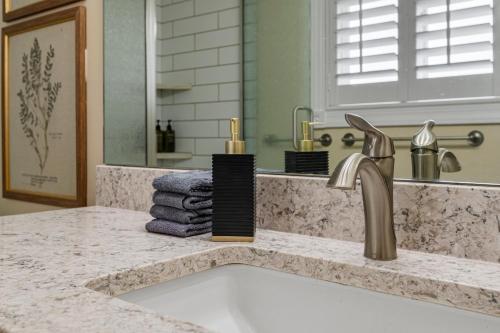 a bathroom counter with a sink and a mirror at Cottage on the hill sleeps 6 views gym office in Parkview Trailer Court