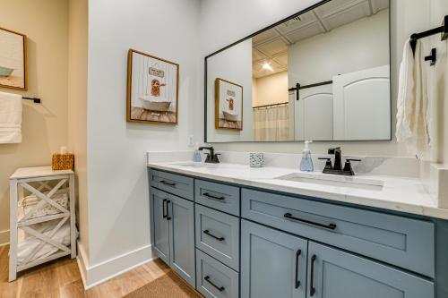 a bathroom with a sink and a large mirror at Lake View and Deck Group Getaway in Grand Rivers! in Grand Rivers