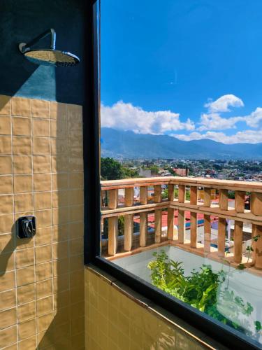 a bathroom with a view of a balcony with a tub at El Diablo y La Luna B&B by El Diablo y La Sandia in Oaxaca City