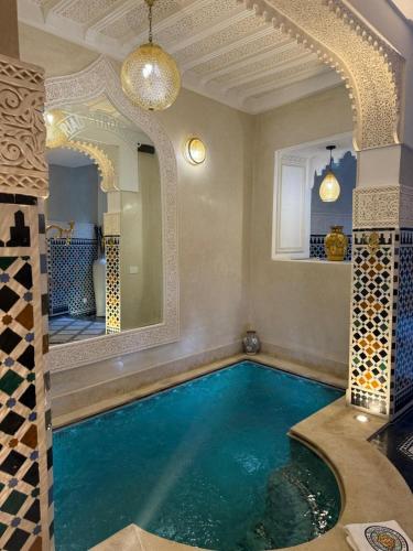a swimming pool in a home with a large mirror at Riad Citronnier & Spa in Fez