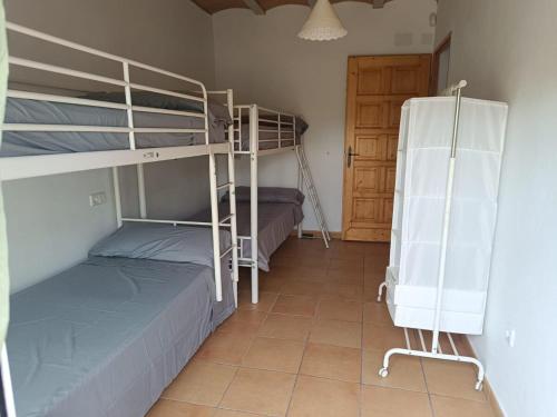 a room with two bunk beds and a door at Chalet en la naturaleza in Macastre